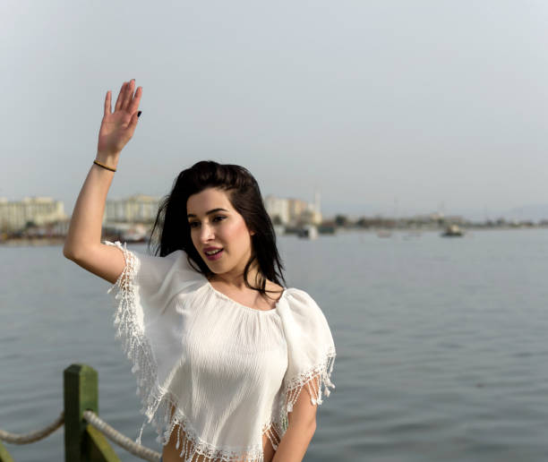 istock Cute young woman waving hand 689488258