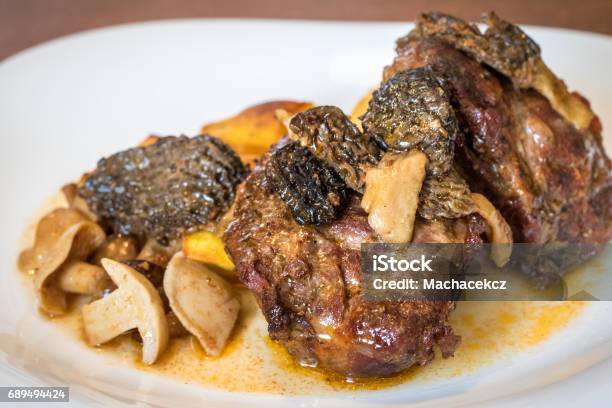 Close Up Shot Of Plate With Baked Pork And Mushrooms Stock Photo - Download Image Now