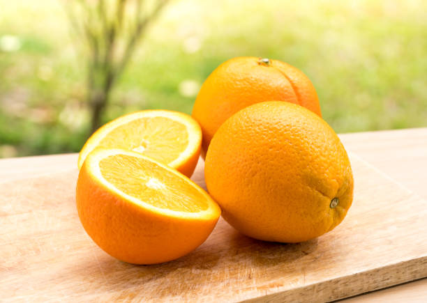istock Orange fruits composition with haft and slice on the wooden table 689497402