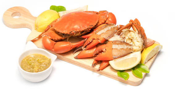 istock Boiled Serrated mud crab  on a wooden plate isolated on white background 689497412