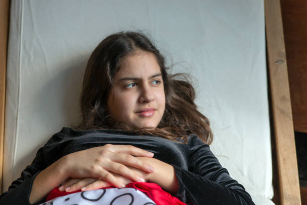 istock Thoughtful girl lying on the bed 689504492