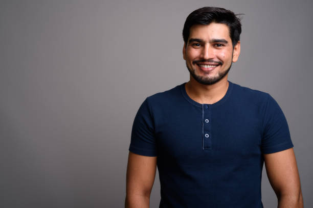 istock Studio shot of young bearded Persian man against gray background 689511056