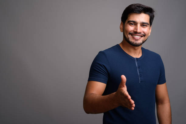 istock Studio shot of young bearded Persian man against gray background 689511478