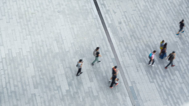 istock blur process of people walk on open space concrete pavement from top view ,bird eye view 689524742