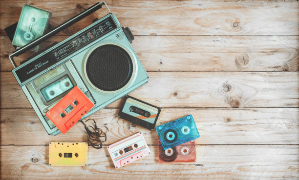 Retro object teachnology Top view hero header - retro technology of radio cassette recorder music with retro tape cassette on wood table. Vintage color effect styles. nostalgia 80s stock pictures, royalty-free photos & images