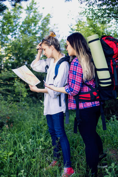 istock Girls with Compass Reading a Map in the forest 689528484