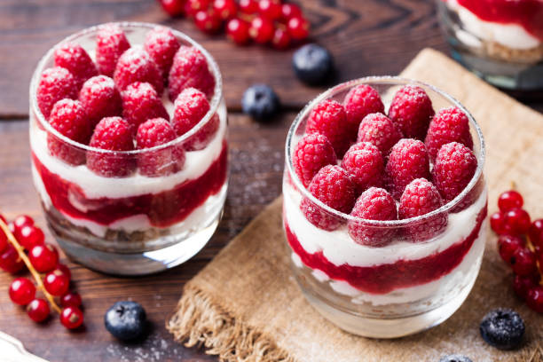 istock Raspberry dessert, cheesecake, trifle, mouse in a glass on a wooden background 689536762