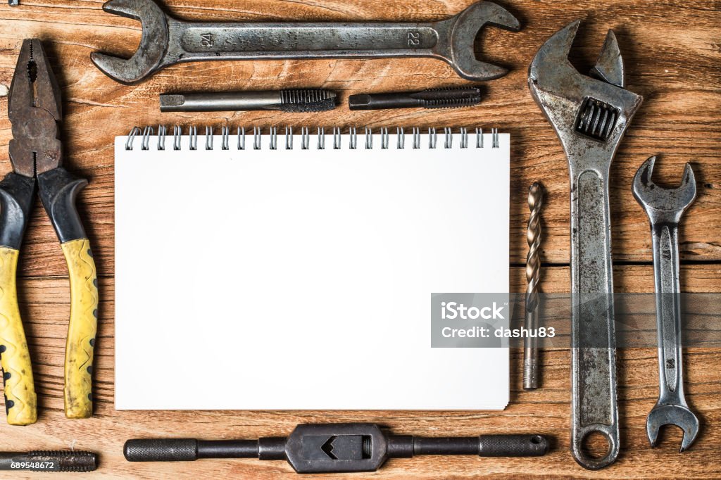 Various tools and the blank notebook on a wooden background Business Finance and Industry Stock Photo