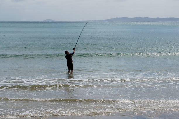 istock Young man fishing 689551384