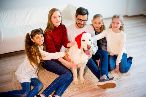 istock Family playing with a dog 689554528