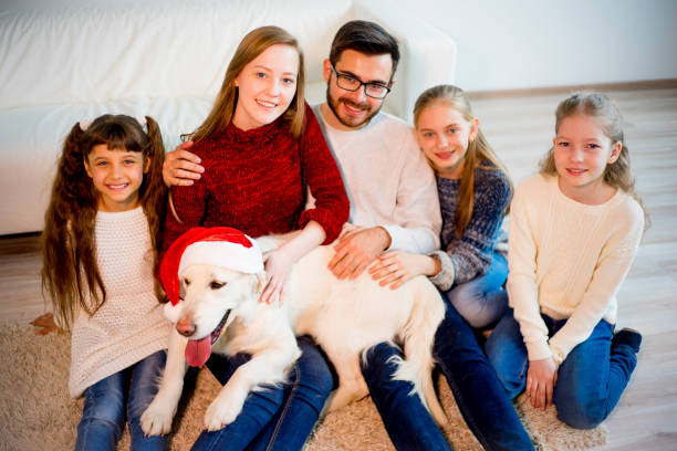 istock Family playing with a dog 689554758
