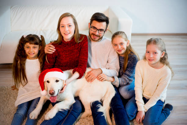 istock Family playing with a dog 689554788