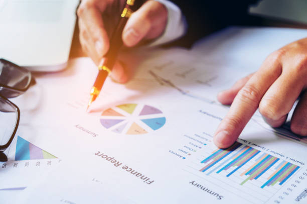 istock hand with a pen writing on the business paper. Report chart 689555556