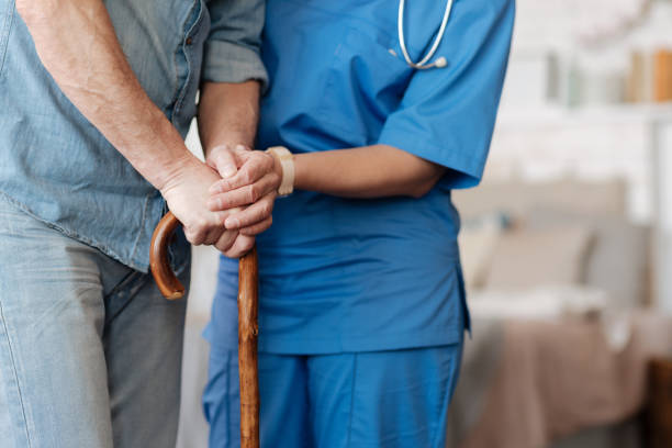 istock Kind trained nurse helping feeble gentleman walking 689561036