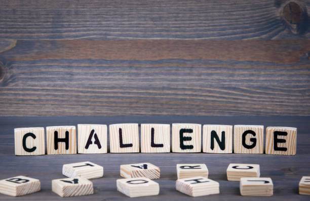 istock Challenge word written on wood block. Dark wood background with texture 689561616