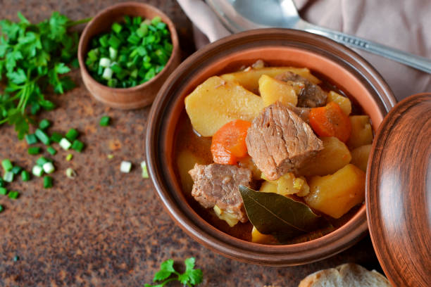 istock Stew with vegetables and potatoes on an old grunge background 689562216