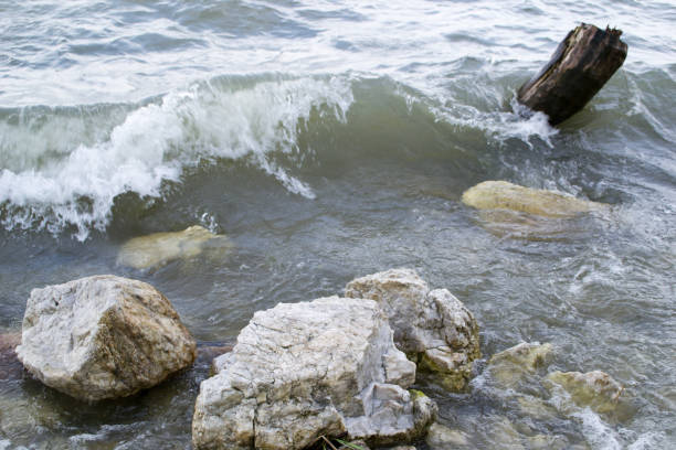 istock Waves breaking rocks on the shore of the lake 689565166