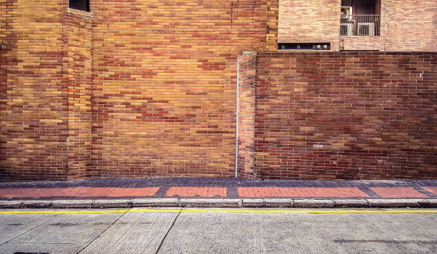 istock street walkway with old red brick wall 689572464