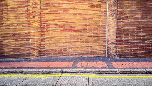 istock street walkway with old red brick wall 689572468