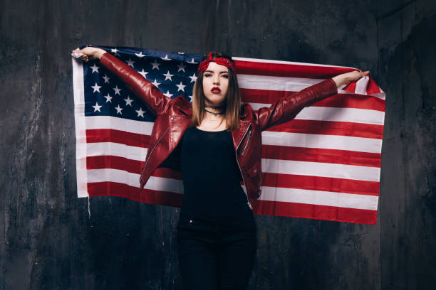 istock Girl with USA flag behind the back 689572552