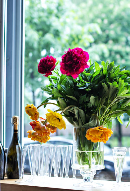 istock Peonies in a vase and champagne glasses on the table. 689572694