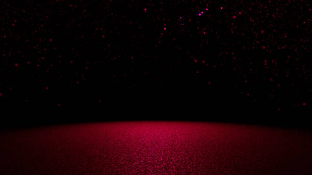 istock sparkling glitter in shades of red, pink and purple falling on a flat surface lit by a bright spotlight 689575388