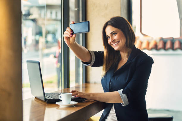 istock Young business woman doing selfie in office 689575894