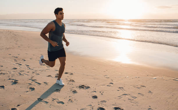 istock Young man training on the beach in morning 689578926