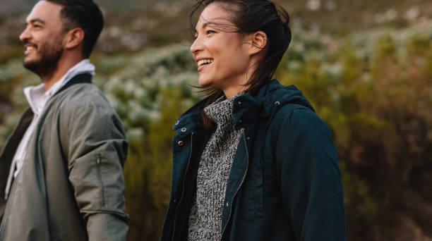 istock Smiling couple hiking in countryside 689582440