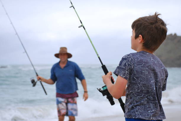 istock Boy and Man Surf Fishing in Summer 689582548