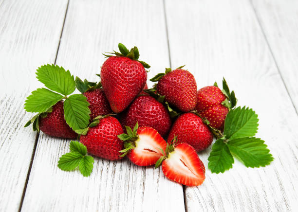 istock ripe strawberries on wooden table 689582774