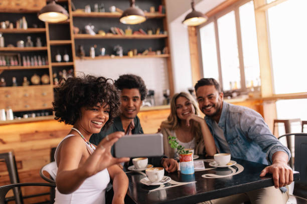 istock Group of friends at restaurant taking selfie 689582898
