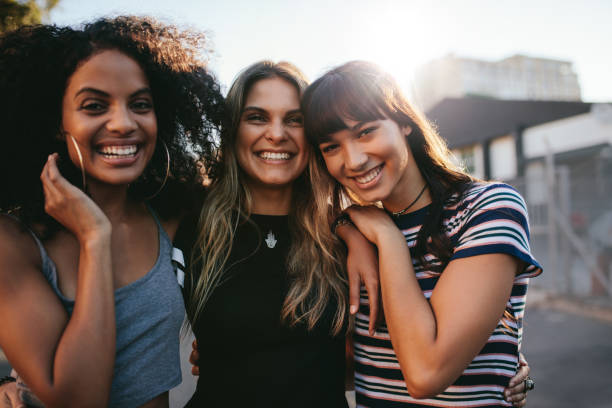istock Three young women having fun on city street 689583246