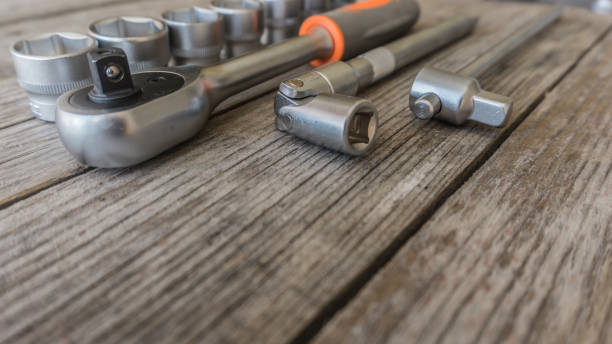 istock Spanner head and power wrench on a wooden table in the workshop 689589096