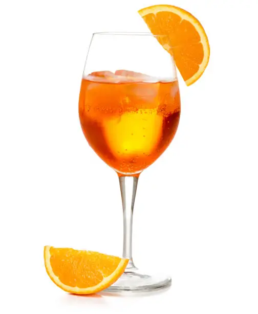 spritz cocktail in a wineglass garnished with orange slice isolated on white