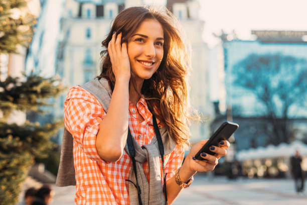 istock Beautiful woman texting outdoors 689593214