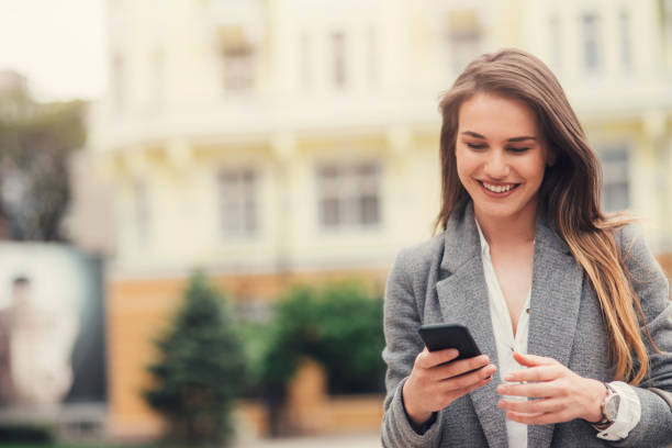 istock Woman texting in the city 689593216