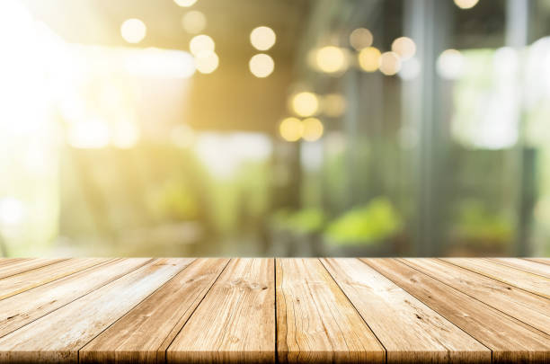 istock Empty light wood table top with blurred in coffee shop background. Can be used for montage products display or design key visual layout. 689602492
