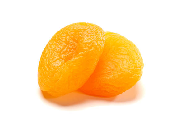 два кураги на белом - carotene healthy eating macro close up стоковые фото и изображения
