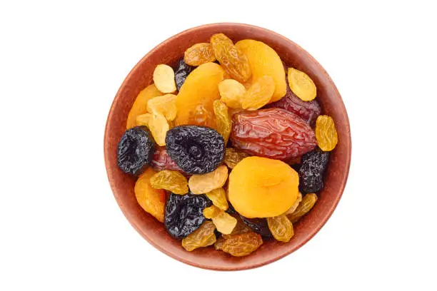 Photo of Bowl of dried fruits mix on white