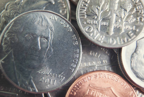 istock Random group of US coins heaped on a white background. 689622876