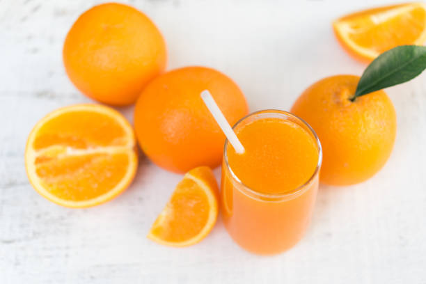 istock Glass of fresh orange juice from top view 689629996