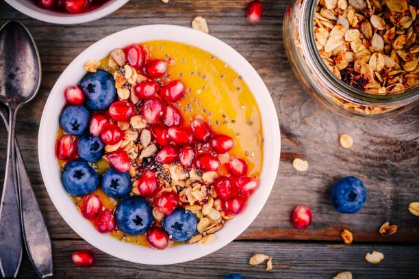 istock Healthy summer breakfast mango  smoothie bowl with granola, blueberries, pomegranate and chia seeds 689639278