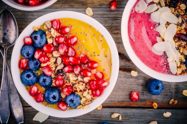 istock Healthy summer breakfast mango and raspberry smoothie bowl with granola, blueberries, pomegranate and chia seeds 689639378