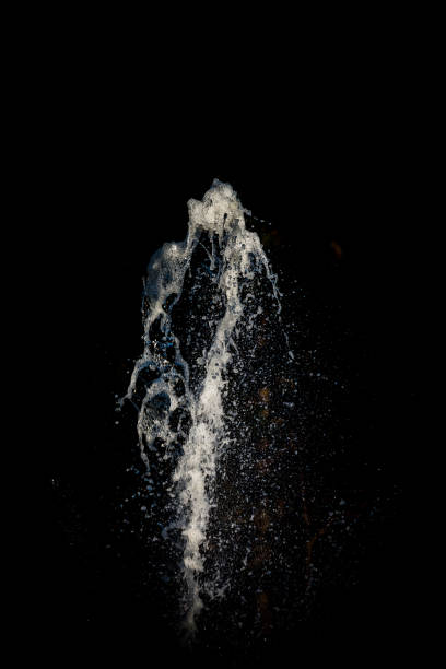 istock Clear water thrusting up in front of a black background 689639696