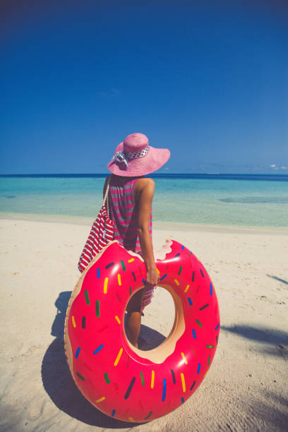 istock Hipster woman standing on beach, Maldives 689644596