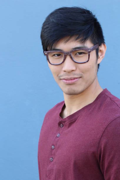 istock Asian man wearing glasses on blue background 689644980