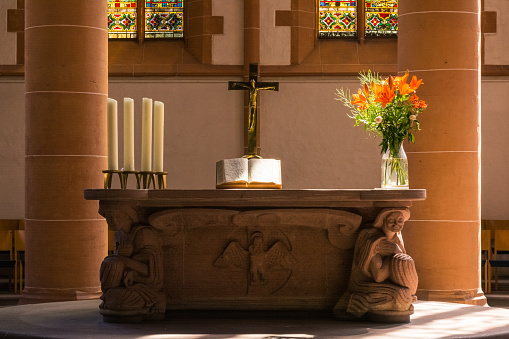 A beautiful view of the interior of the Duomo of Gualdo Tadino, a medieval small town in the Umbria region, in central Italy. Built in Romanesque style starting in 1256, the Duomo or Cattedrale di San Benedetto (Cathedral of St. Benedict of Nursia) is among the best preserved major churches in the region. The interior of the church consists of three naves, a cross vault and a semicircular apse. In the background in the center the precious high altar, rebuilt with elements of the 14th century, composed with bas-reliefs depicting episodes from the life of St. Benedict. The Umbria region, considered the green lung of Italy for its wooded mountains, is characterized by a perfect integration between nature and the presence of man, in a context of environmental sustainability and healthy life. In addition to its immense artistic and historical heritage, Umbria is famous for its food and wine production and for the high quality of the olive oil produced in these lands. Wide angle image in high definition quality.