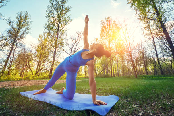 Young woman doing yoga exercises in the summer city park. Health lifestyle concept Young woman doing yoga exercises in the summer city park. beautiful traditional indian girl stock pictures, royalty-free photos & images