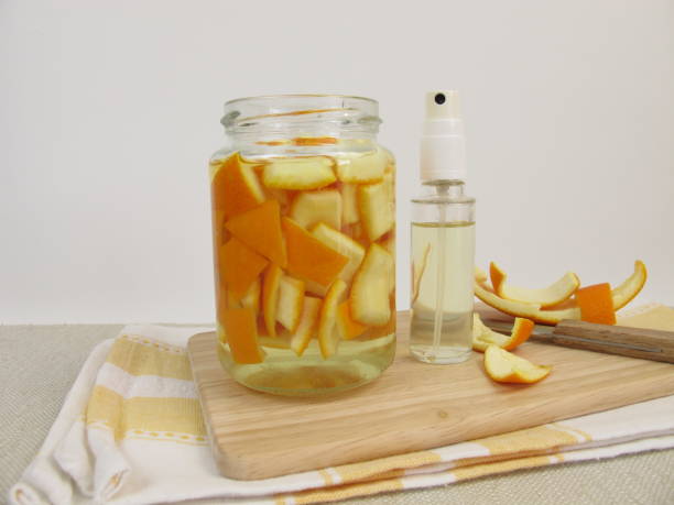 Organic household detergent with orange peel and vinegar in spray bottle stock photo